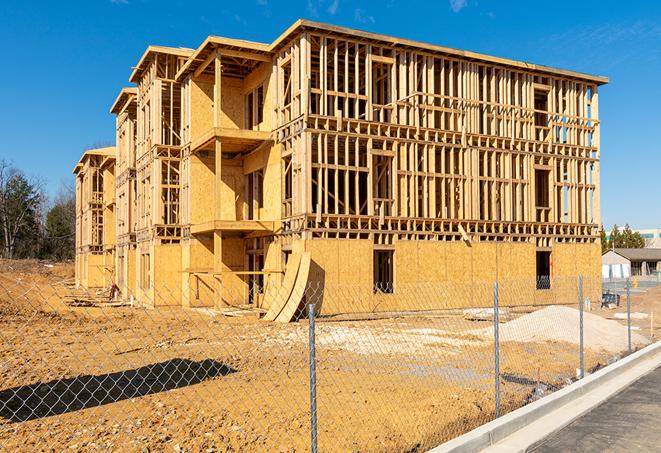 a construction site enclosed by temporary chain link fences, ensuring safety for workers and pedestrians in Beggs, OK